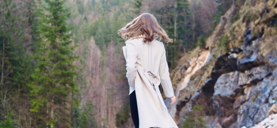 Woman in coat standing in forest 🌳 Nature Fashion Photography ✨